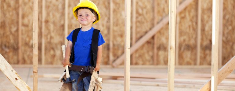 A happy little boy wants to be a carpenter when he grows up. He'll hammer it out for you.