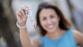 Real estate agent holding keys to a house